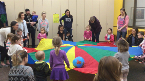 Participants playing with parachute