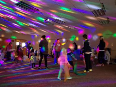 colored disco lights and people dancing