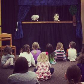 kids watching a puppet show
